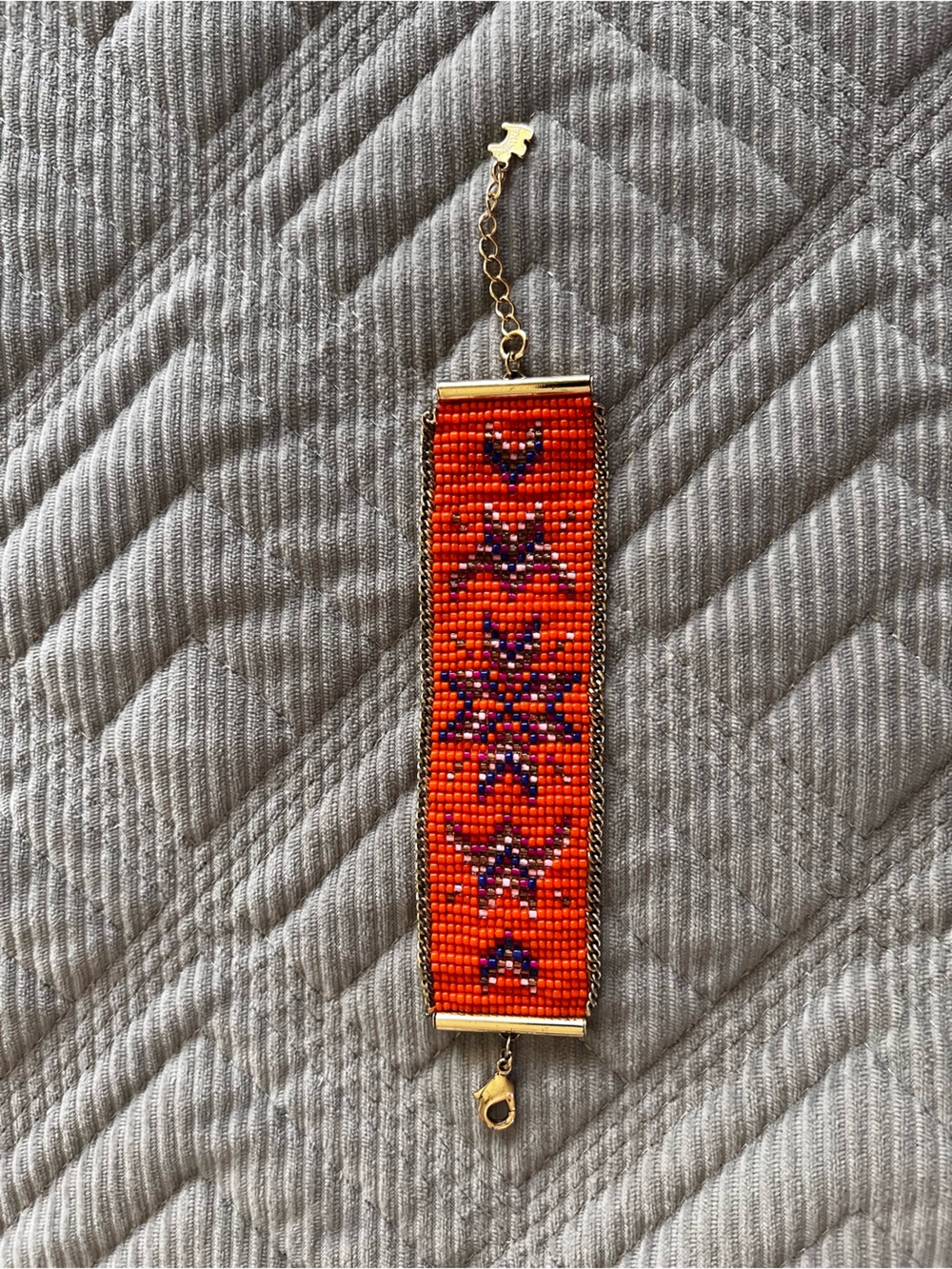 Vibrant Orange Seed Bead Bracelet with Purple Star Motif